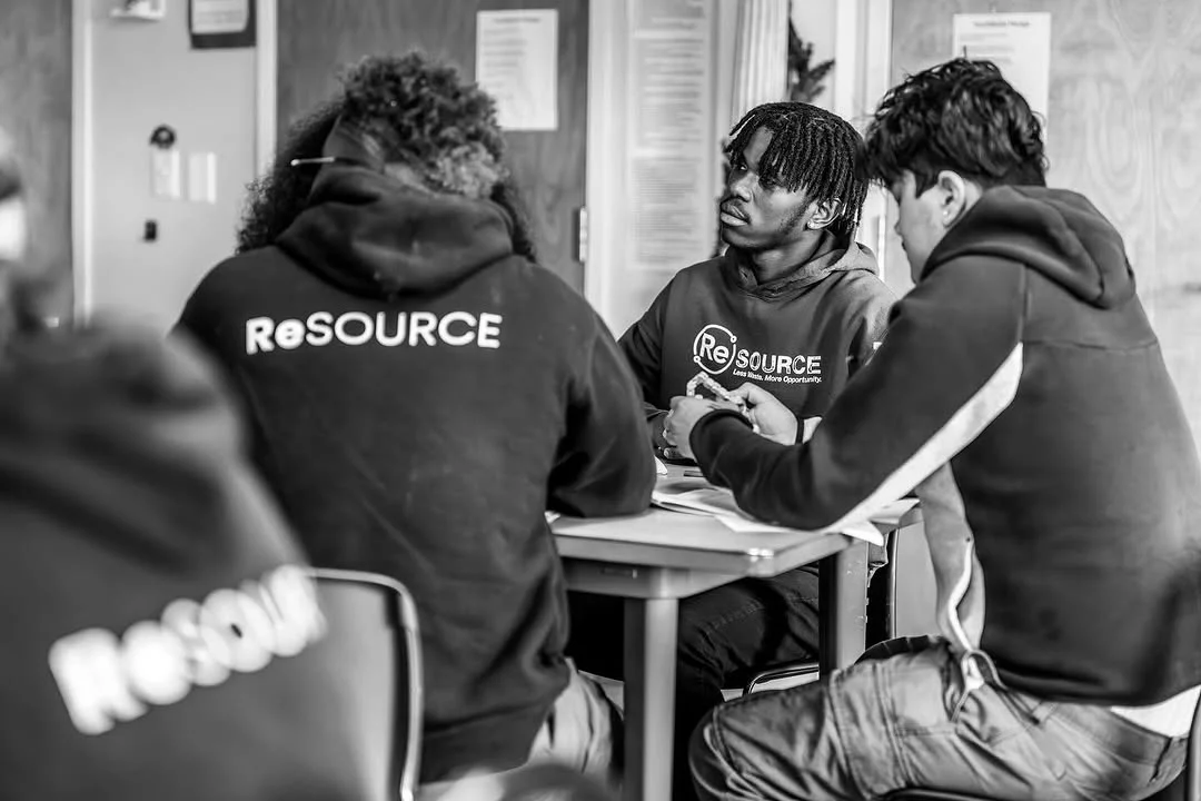 ReSOURCE participants gather around a small table for a discussion.