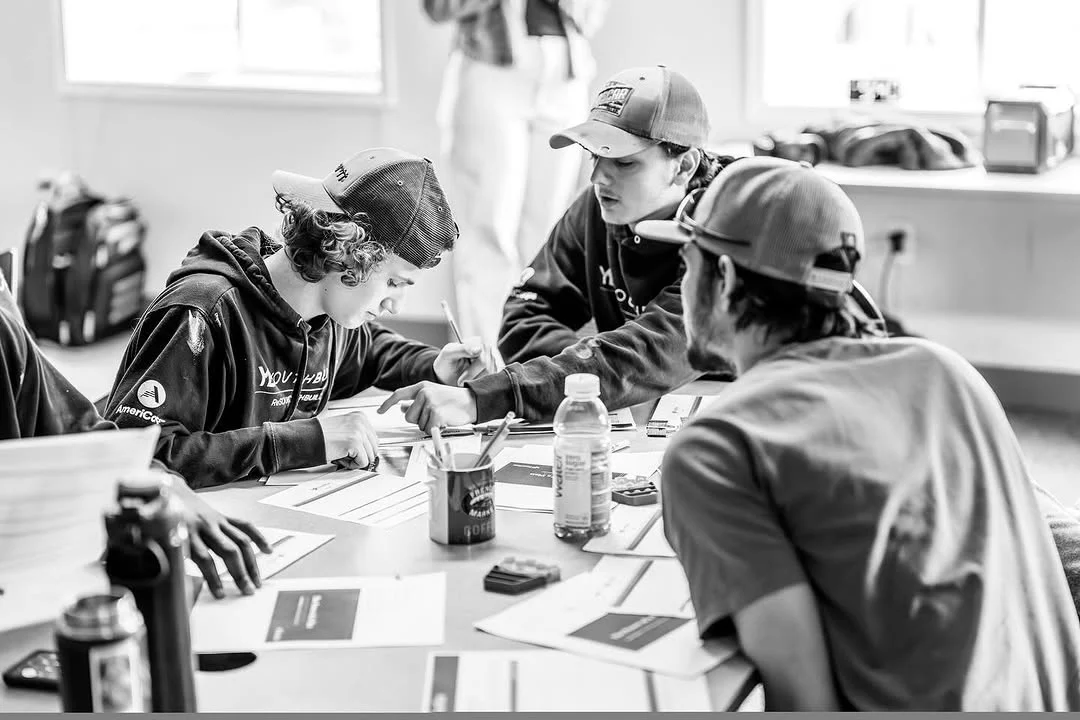 Participants complete worksheets together at classroom tables.