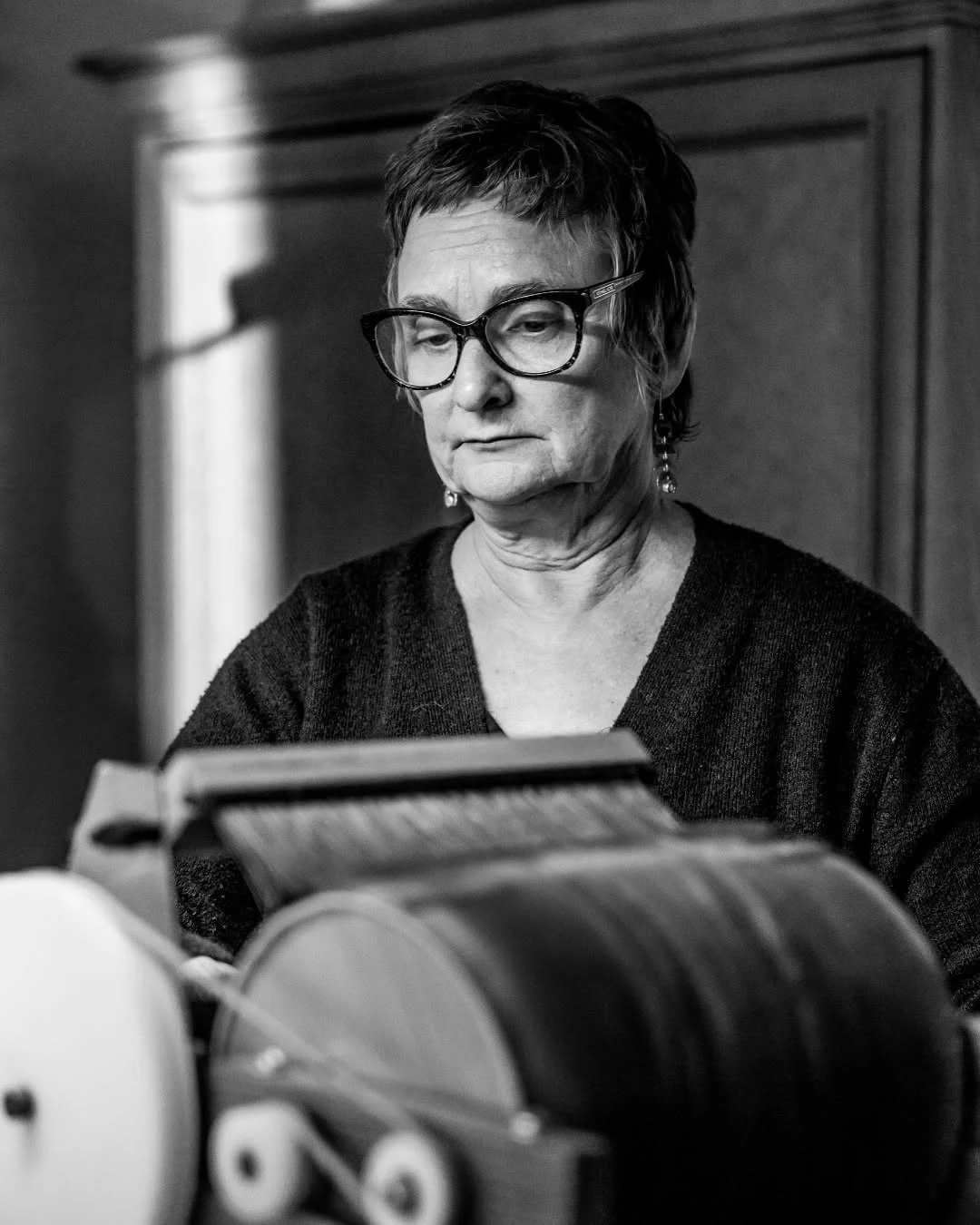 Susi Ryan works at a fiber-processing machine in her studio.