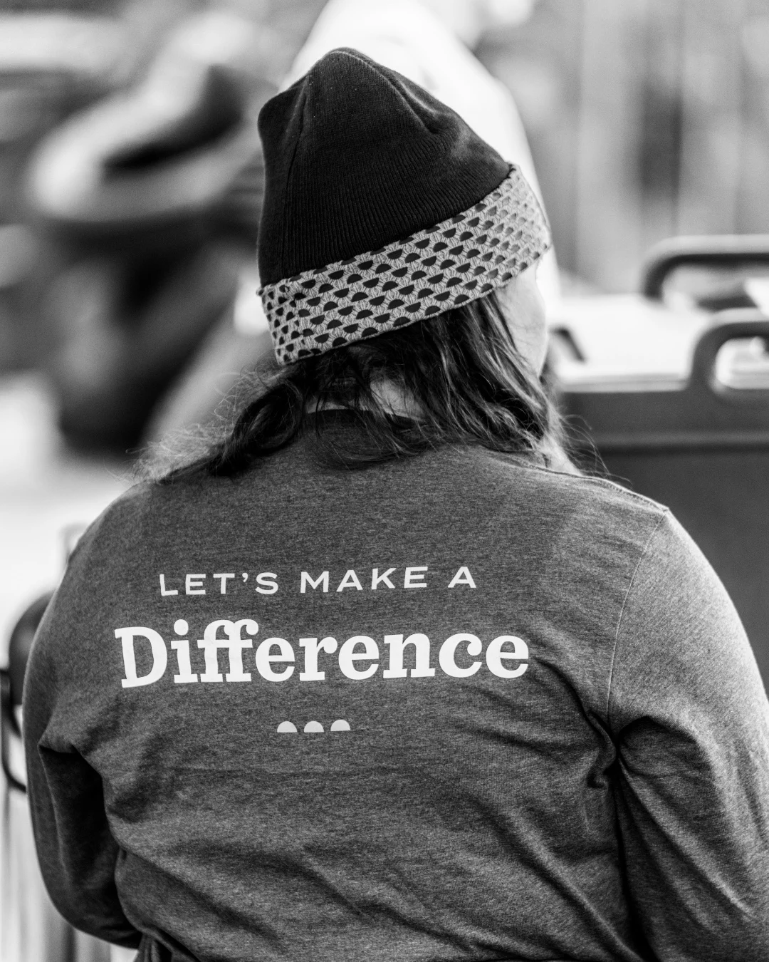 The back of a volunteer's shirt reads, 'Let's Make a Difference.'