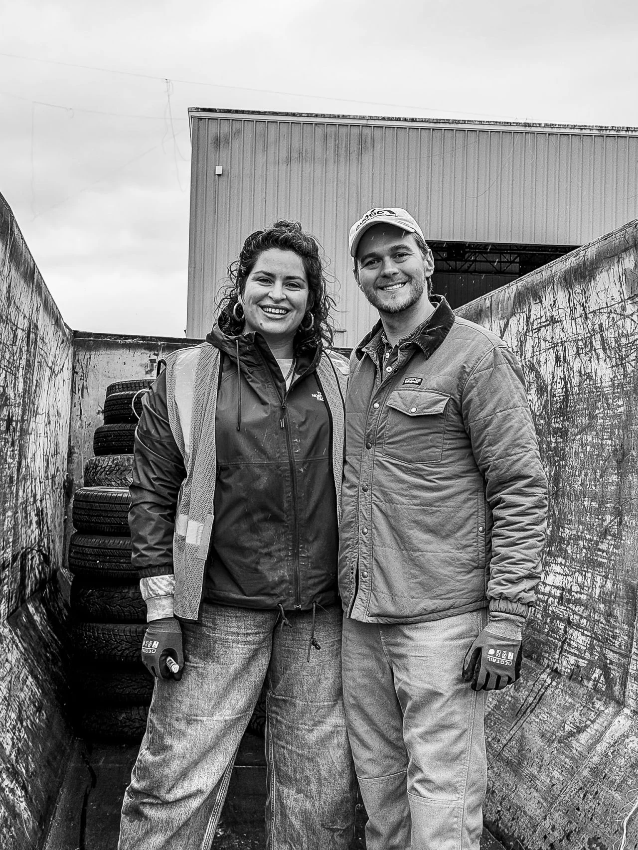 Two volunteers pose together outside a Wheels for Warmth donation site.