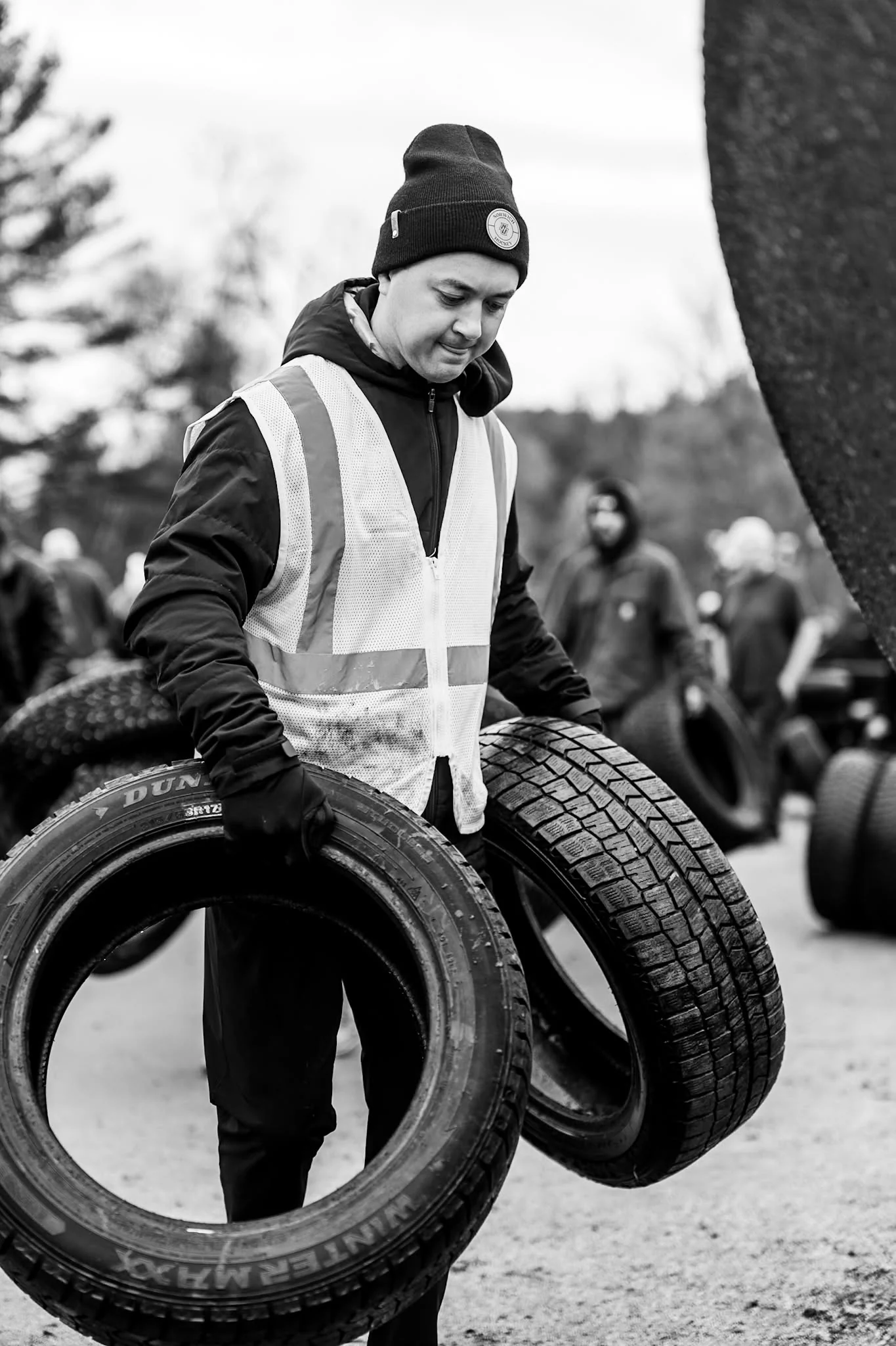 Volunteers talk beside rows of tires at the Wheels for Warmth collection.