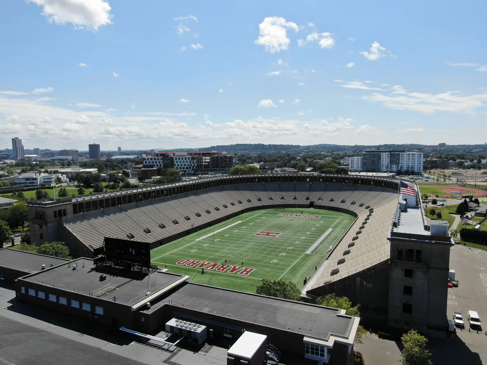 Aerial view into Harvard Stadium with its horseshoe grandstand and red H at midfield