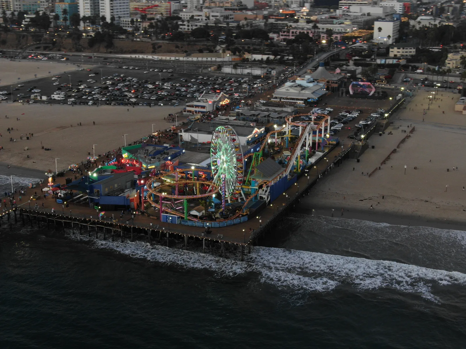 Wide aerial view of Santa Monica Pier, the beach, and surrounding city streets