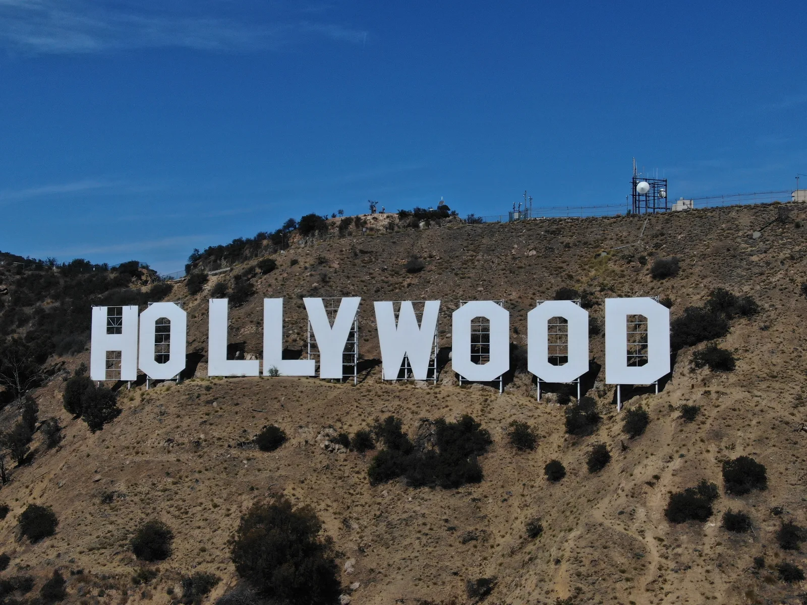 Close aerial view of the Hollywood Sign beneath a clear blue sky