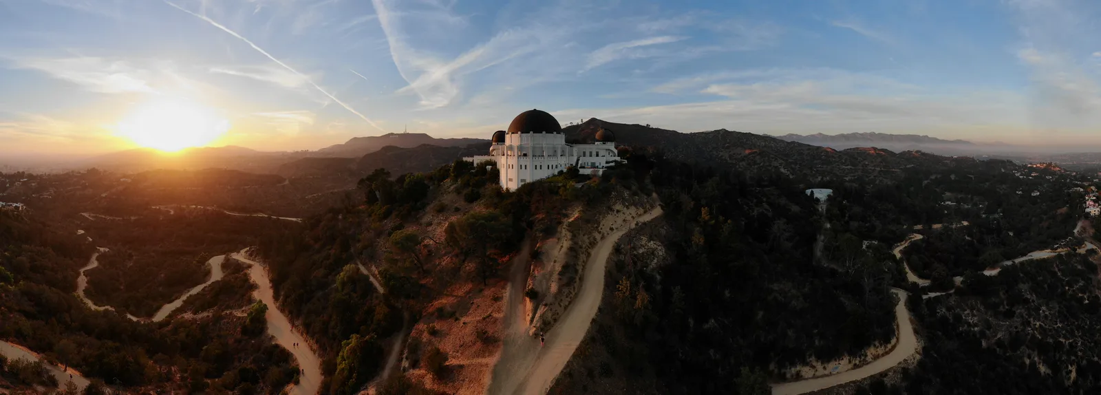 Panoramic sunset view of Griffith Observatory and the surrounding Los Angeles hills