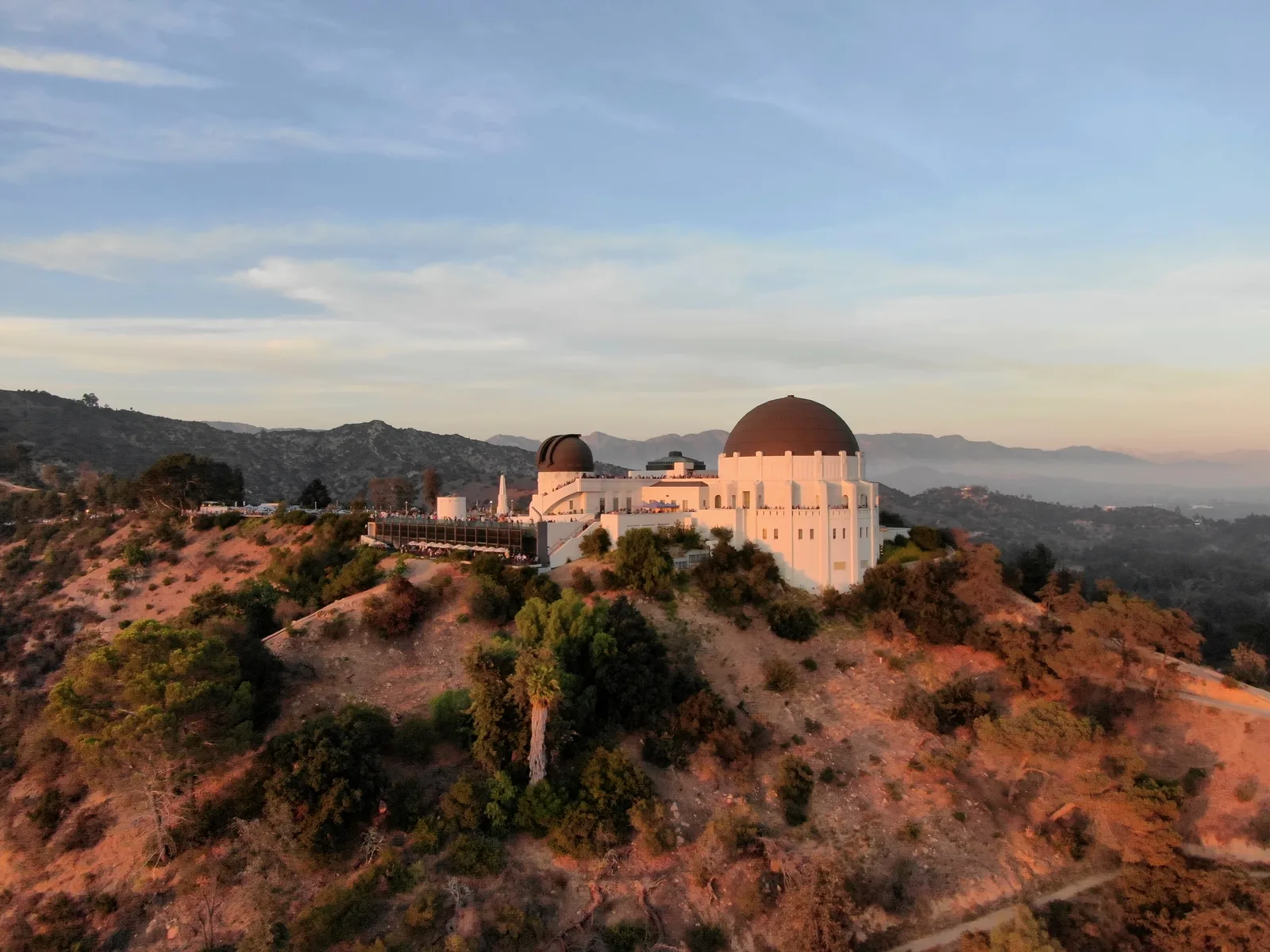 Griffith Observatory and its domes lit by warm evening sunlight