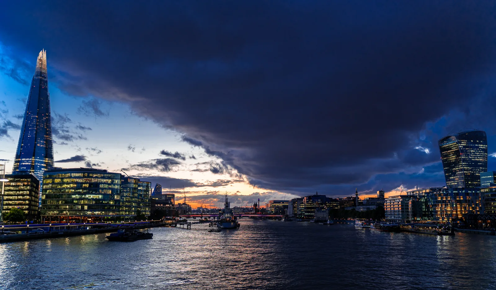 The Shard and riverside buildings beside the River Thames at blue hour