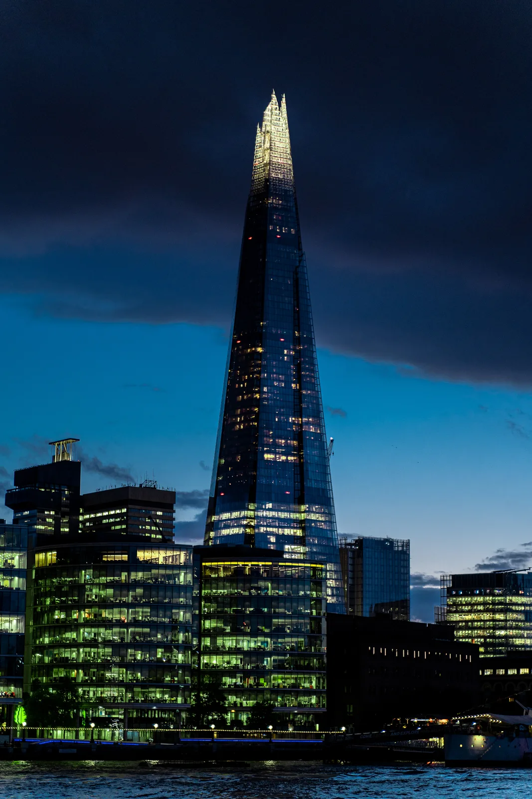 The Shard rising above illuminated London buildings at dusk